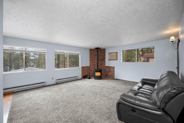 living room featuring a wood stove, a textured ceiling, an AC wall unit, and a baseboard heating unit