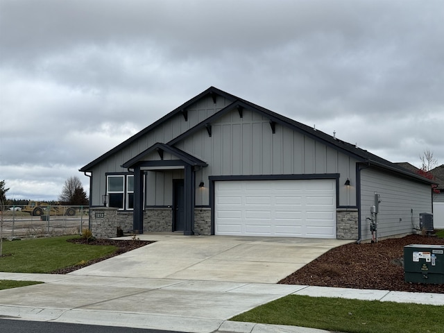 view of front of property with a garage and central air condition unit