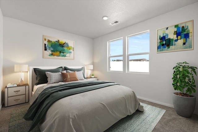 carpeted bedroom with a textured ceiling