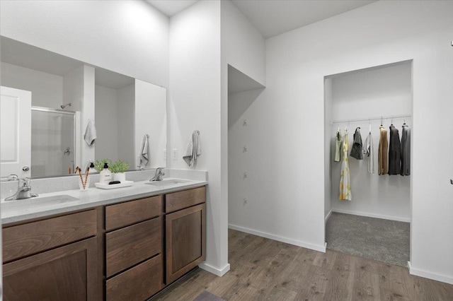 bathroom featuring vanity, an enclosed shower, and hardwood / wood-style flooring