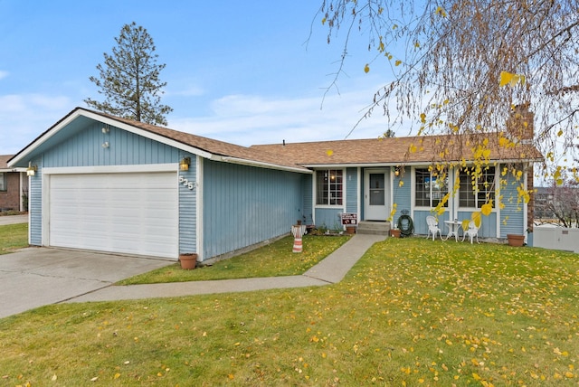 ranch-style house with a garage and a front lawn