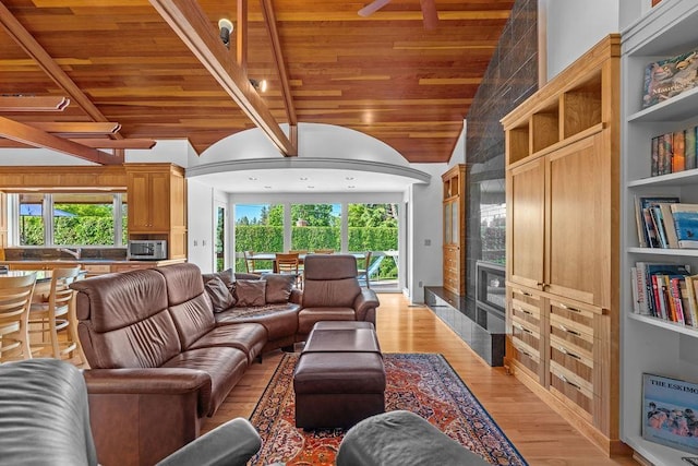 living room with light wood-type flooring, built in features, a wealth of natural light, and wooden ceiling