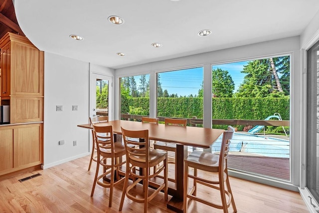 dining room featuring plenty of natural light and light hardwood / wood-style flooring