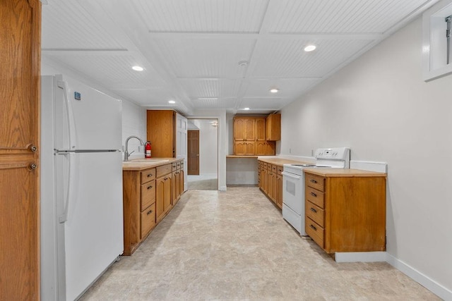 kitchen featuring white appliances and sink