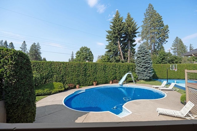 view of pool with a water slide