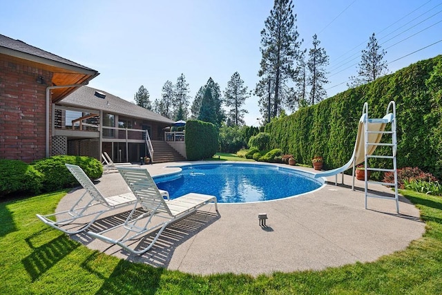 view of pool with a patio area and a water slide