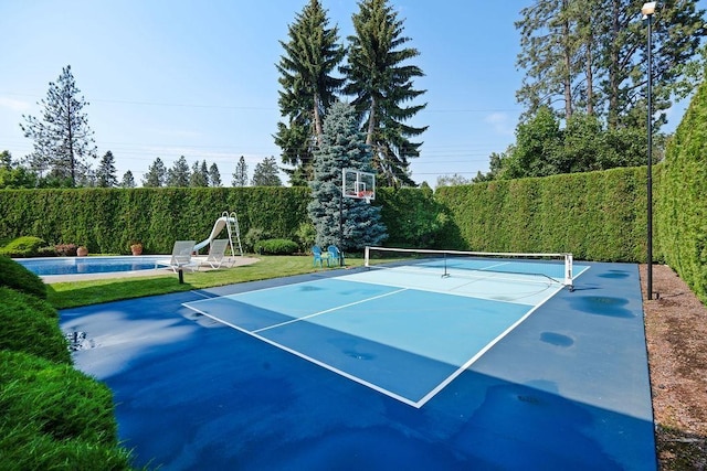 view of sport court featuring basketball hoop