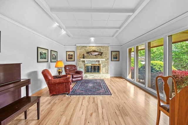 living room with rail lighting, a fireplace, and light hardwood / wood-style flooring