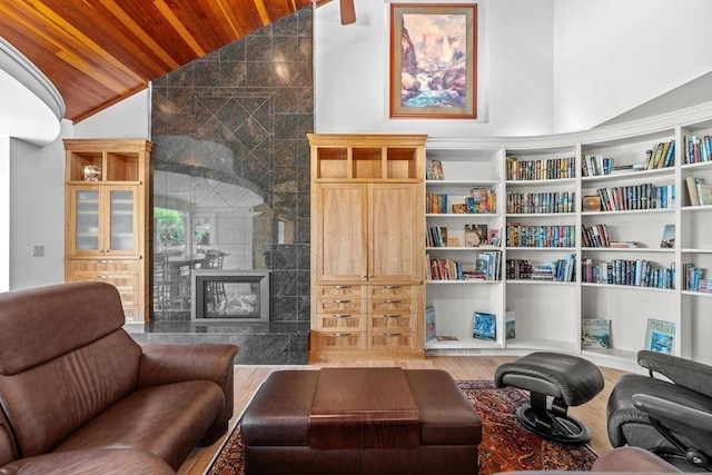 living room featuring a fireplace, hardwood / wood-style floors, vaulted ceiling, and wooden ceiling