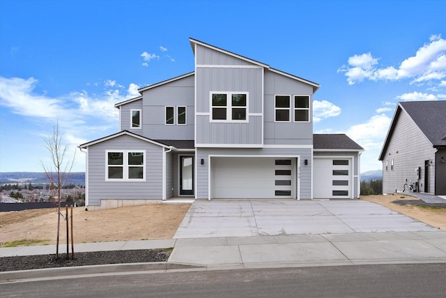 contemporary house featuring board and batten siding, concrete driveway, and a garage