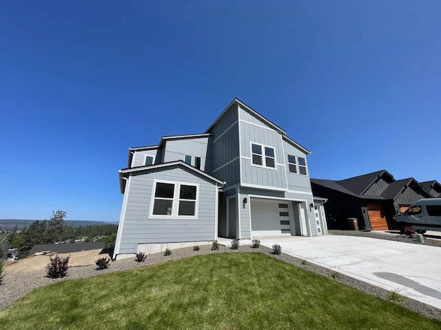 4706 W Lex Ave Lot 5, Spokane, WA 99208 - contemporary house featuring an attached garage, concrete driveway, board and batten siding, and a front lawn