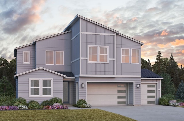 view of front facade featuring a garage and a yard