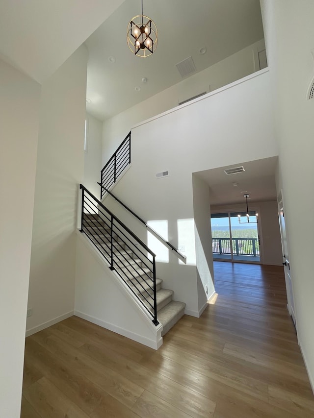 4706 W Lex Ave Lot 5, Spokane, WA 99208 - stairs featuring a chandelier, wood finished floors, and a towering ceiling