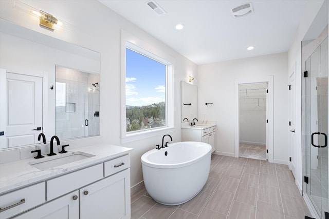 4706 W Lex Ave Lot 5, Spokane, WA 99208 - full bathroom featuring a stall shower, two vanities, a freestanding tub, a walk in closet, and recessed lighting