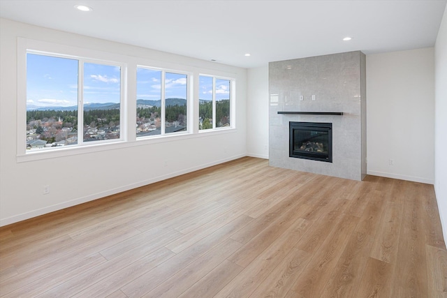 4706 W Lex Ave Lot 5, Spokane, WA 99208 - unfurnished living room featuring a mountain view, light wood-style flooring, a fireplace, and recessed lighting
