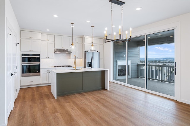 4706 W Lex Ave Lot 5, Spokane, WA 99208 - kitchen featuring stainless steel refrigerator with ice dispenser, under cabinet range hood, gas cooktop, light countertops, and white cabinetry