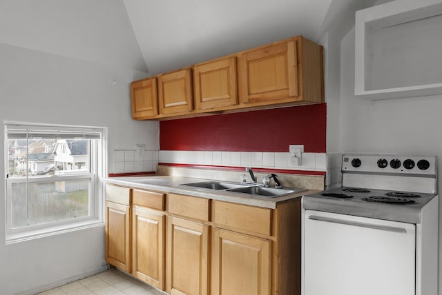 kitchen with sink, vaulted ceiling, and electric stove