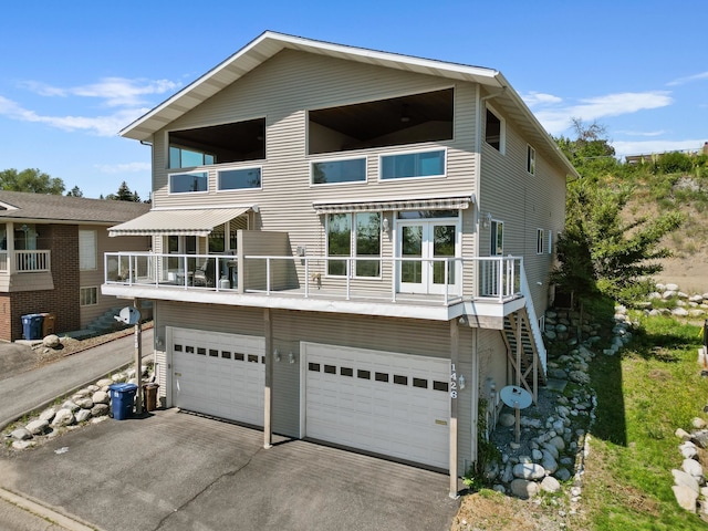 view of front of home featuring a balcony and a garage