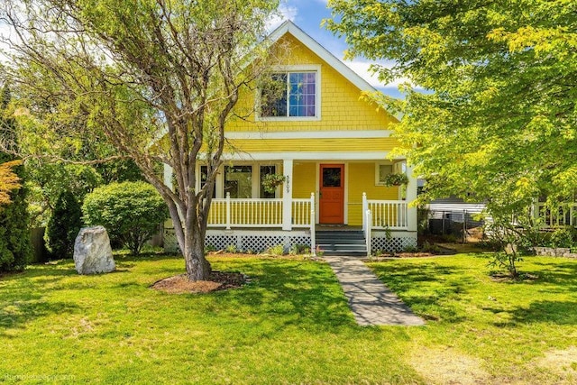 view of front of house with covered porch and a front yard