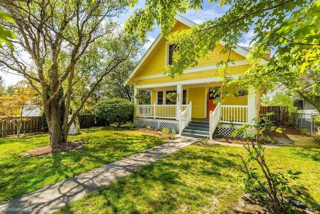 view of front of home with a porch and a front lawn