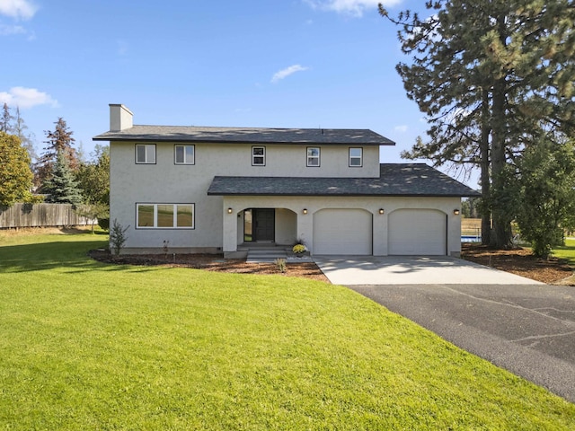 front facade featuring a front yard and a garage