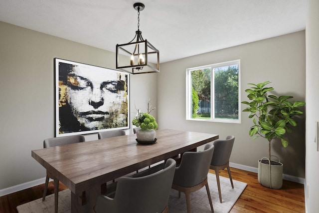 dining space featuring hardwood / wood-style floors and a chandelier