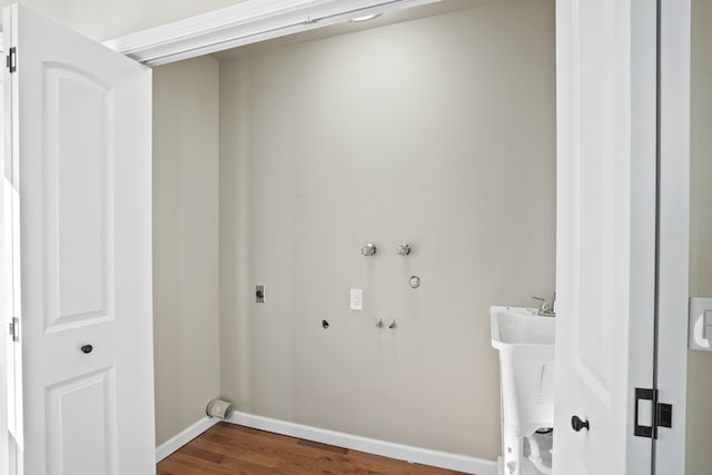 clothes washing area with wood-type flooring, hookup for a washing machine, hookup for a gas dryer, and electric dryer hookup