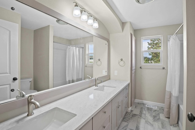 full bathroom featuring vanity, shower / bath combination with curtain, and toilet