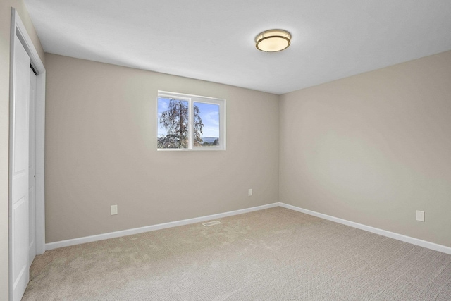 unfurnished bedroom with carpet flooring and a closet