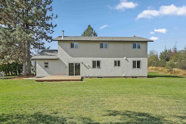 rear view of house featuring a yard and a wooden deck