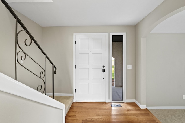 foyer entrance with light hardwood / wood-style flooring