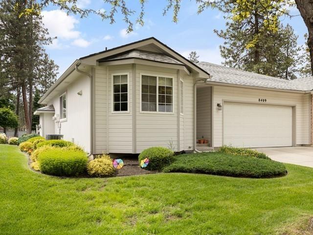 view of front of property with a front lawn and a garage