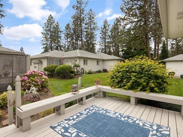 wooden deck featuring a lawn