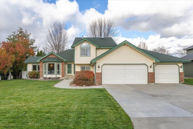 view of front of property with a front yard and a garage