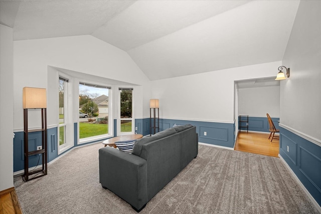 living room with lofted ceiling and light carpet