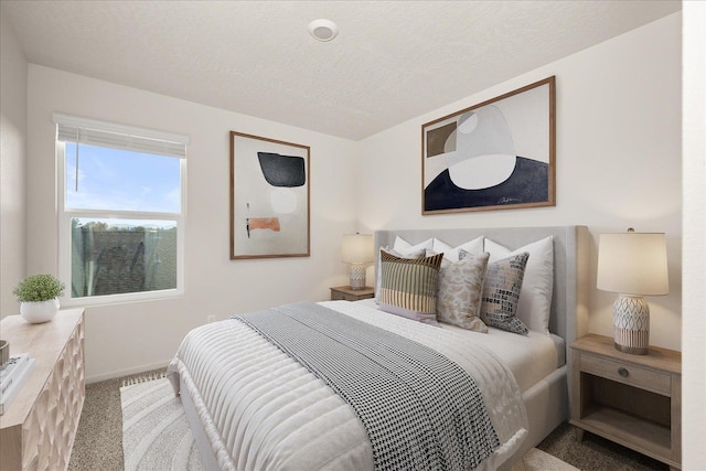 carpeted bedroom featuring a textured ceiling