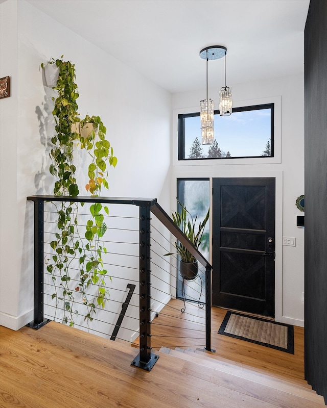 entrance foyer with wood-type flooring and an inviting chandelier