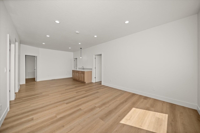 4233 W Tolliver Ct, Spokane, WA 99208 - unfurnished living room featuring recessed lighting and light wood-type flooring