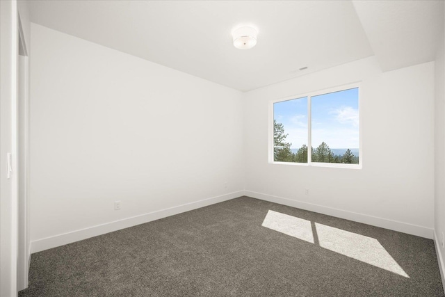 4233 W Tolliver Ct, Spokane, WA 99208 - unfurnished room featuring baseboards and dark colored carpet