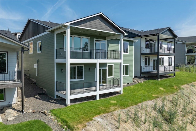 4233 W Tolliver Ct, Spokane, WA 99208 - rear view of property featuring a balcony and a yard