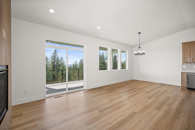 4233 W Tolliver Ct, Spokane, WA 99208 - unfurnished living room featuring a chandelier, light wood finished floors, vaulted ceiling, and recessed lighting