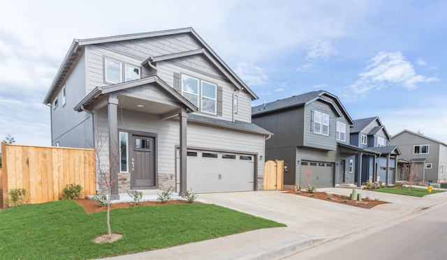 craftsman inspired home featuring a garage and a front lawn