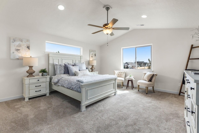 bedroom featuring ceiling fan, vaulted ceiling, carpet floors, and multiple windows