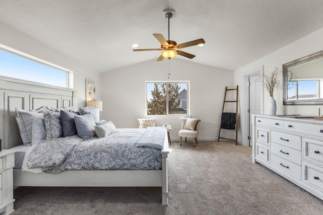 bedroom with a textured ceiling, ceiling fan, light carpet, and vaulted ceiling