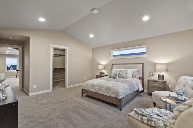 carpeted bedroom featuring a spacious closet, a closet, and vaulted ceiling