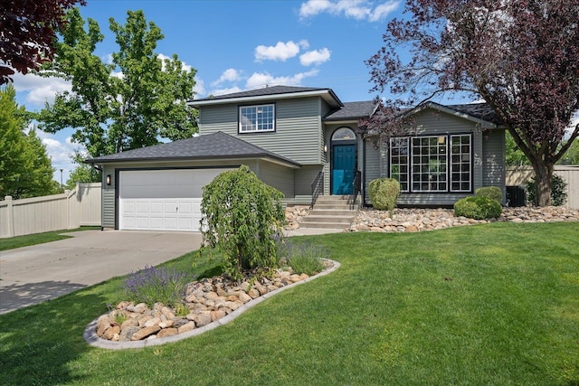 view of front facade featuring a front yard and a garage