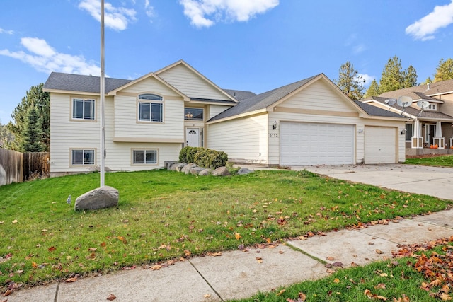 view of front of property featuring a front yard and a garage