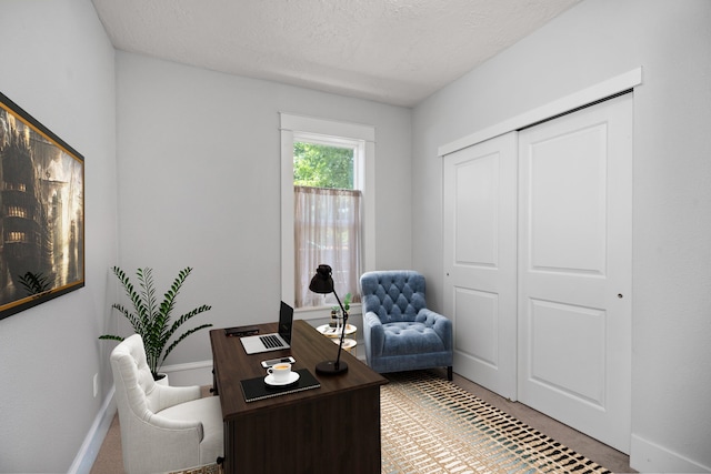 home office featuring a textured ceiling