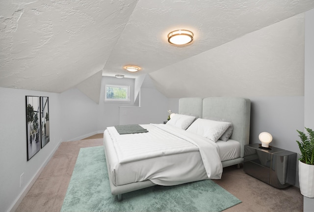 carpeted bedroom featuring lofted ceiling and a textured ceiling