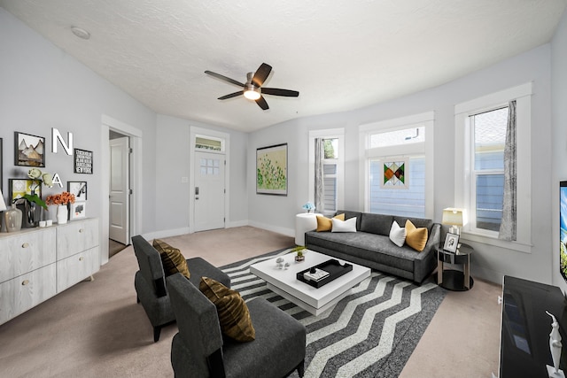 living room featuring light colored carpet and a textured ceiling